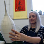 Rhian Malin decorating a mandala bottle in her workshop 2019